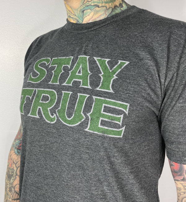 Available at True Tattoo Supply. Stay true! Large print on the front states the obvious, STAY TRUE, small True Tattoo logo on the back, Dark heather gray shirt with distressed print. Available in S-XXL