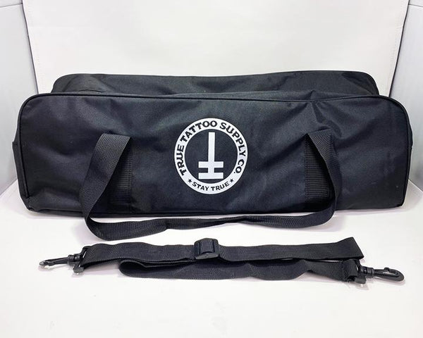 Available at True Tattoo Supply. Armrest Travel Bags for your True Tattoo Armrest!  This convenient travel bag is perfect to fit your True Armrest as well as extra parts you may need while traveling! Two Handles for easy carrying and comes along with a strap for shoulder carrier.   Bag measures: L - 24" H - 7" W - 7" Made Of: Nylon, Plastic