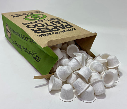 Available at True Tattoo Supply. Eco-Friendly Paper Ink Caps - 15mm - 200 pcs per bag Each ink cap is made from molded paper stock. Artists can lower their carbon footprint and help protect the environment too. Each ink cap is made from thick, pressed, and molded paper stock and packaged in a classic brown paper bag. 200pcs/bag Some ink brands may experience a leaking issue. When using black or red, recommendation is 2 caps.